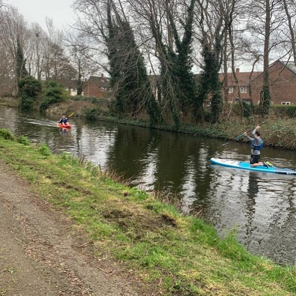 People paddleboarding as part of the Impact Sefton project